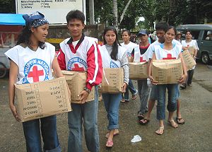 Red Cross volunteers delivering relief boxes to Catarman flood victims photo